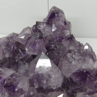 Amethyst crystal cluster on a white background
