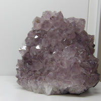 Amethyst crystal cluster standing display with cut base and sparkling purple points – calming décor from Star Woman Crystals