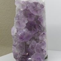 Front view of raw amethyst cluster with large terminated points and lilac hues, 5-lb display piece for peace and protection.