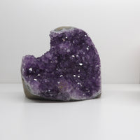 Amethyst crystal on a white surface
