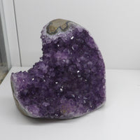 Amethyst crystal on a white surface