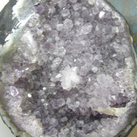 Close-up of a crystal formation with purple and clear crystals.