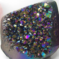 Multicolored Aura quartz crystal cluster on a white background