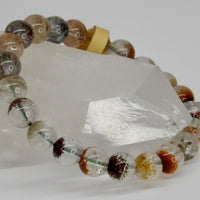 High-quality 10mm Garden Quartz bracelet featuring clear natural quartz beads with colorful red, green, brown, and earthy mineral inclusions.