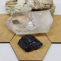 Moonstone Necklace on semi polished clear quartz point with rainbows and black tourmaline