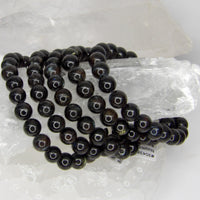 Natural 8mm Nuummite stretch bracelet with polished charcoal-black gemstone beads.