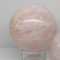 Polished rose quartz sphere on stand, heart chakra crystal