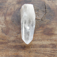 clear quartz point on brown table