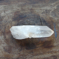 Clear quartz point on wooden table
