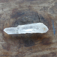 Natural clear quartz point on table