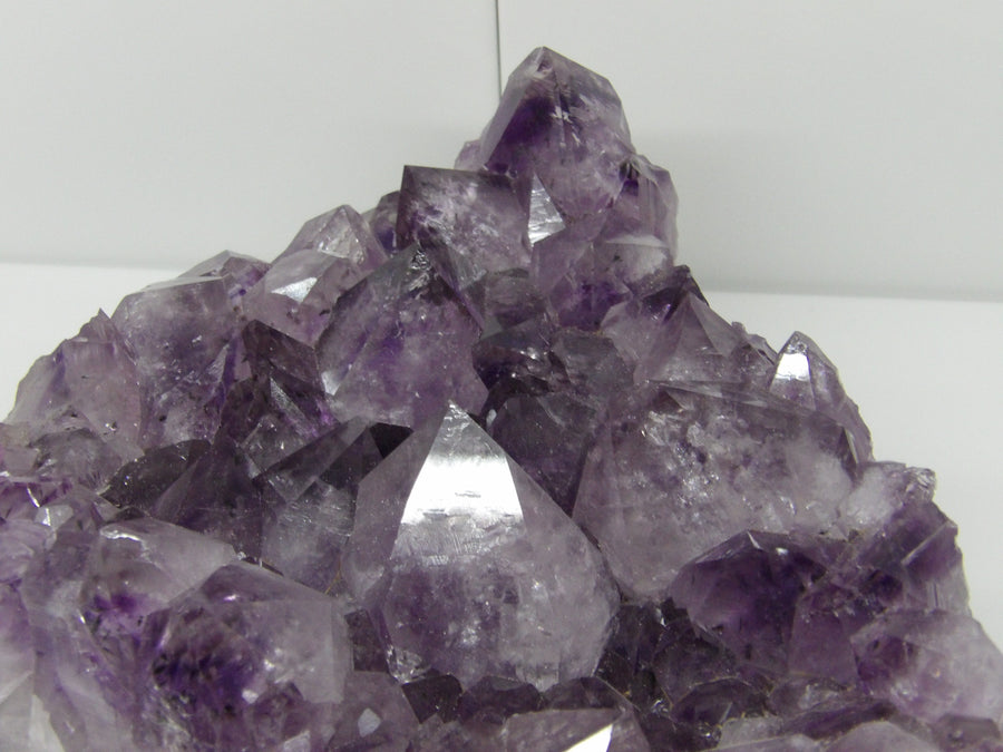 Amethyst crystal cluster on a white background