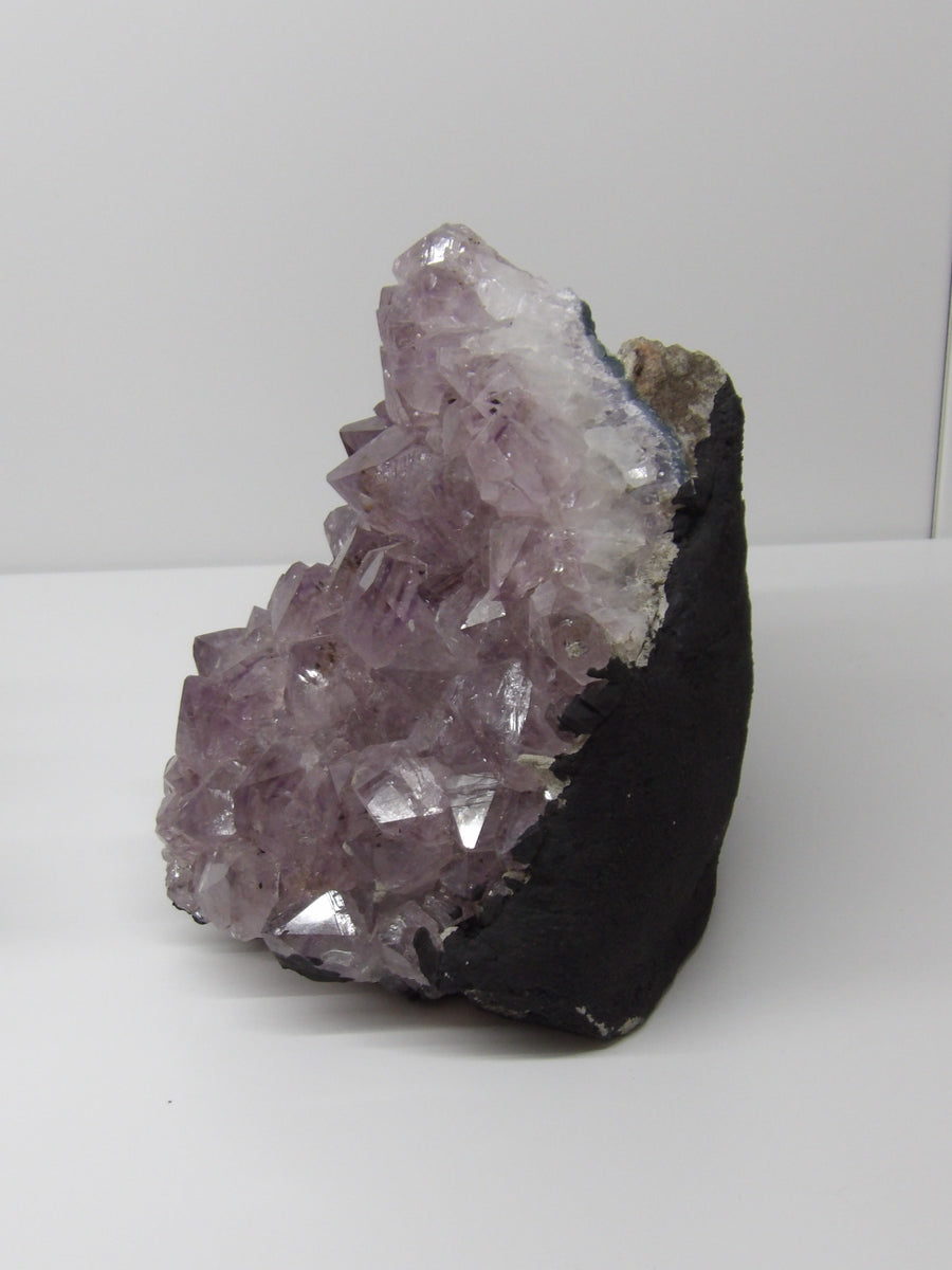 Side view of Amethyst stalactite cluster showing dark matrix and radiant lavender crystals – 4.2 lb hand-cleansed piece