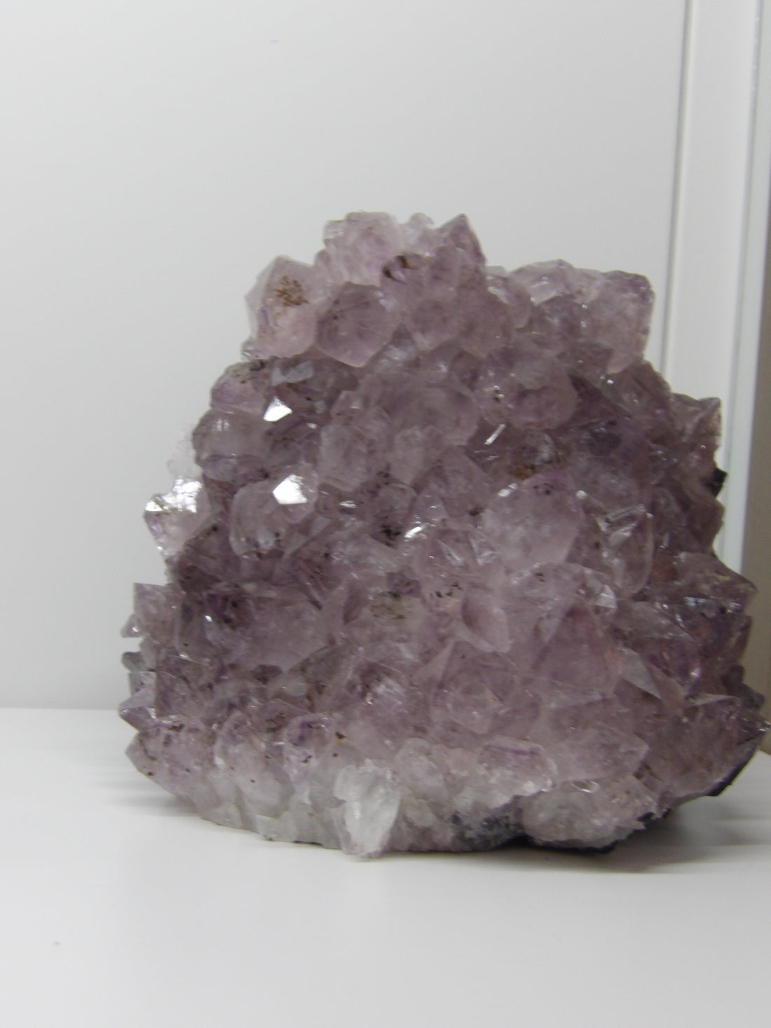Amethyst crystal cluster standing display with cut base and sparkling purple points – calming décor from Star Woman Crystals