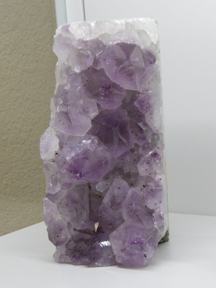 Front view of raw amethyst cluster with large terminated points and lilac hues, 5-lb display piece for peace and protection.