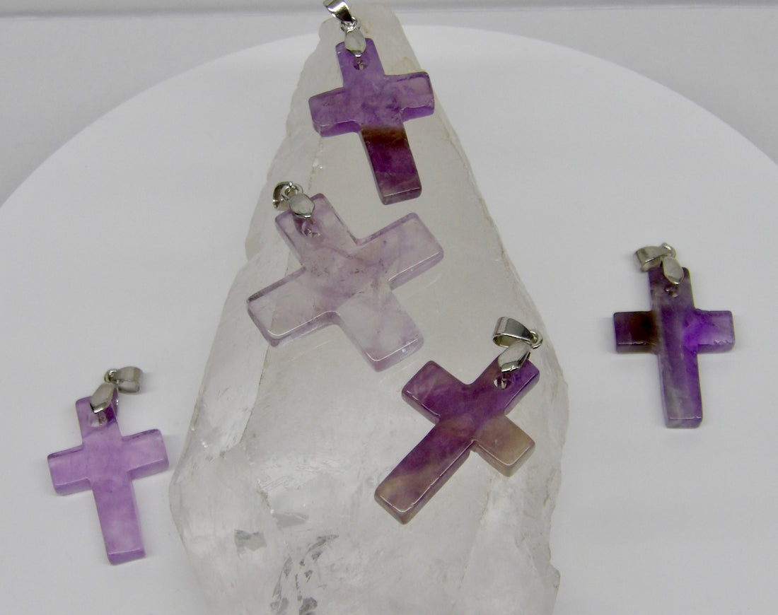 Natural Amethyst carved cross pendants in varying shades of lavender and purple