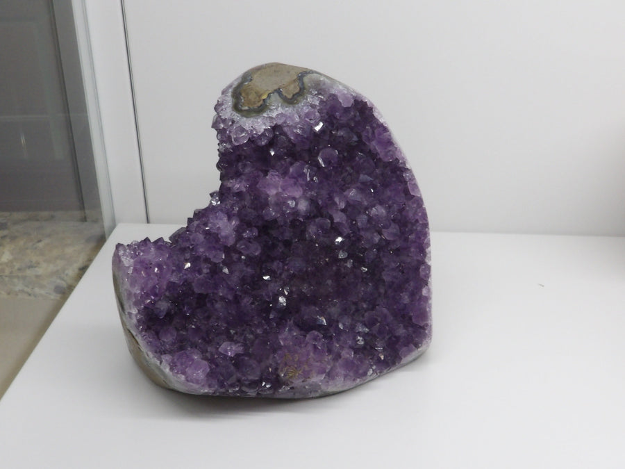 Amethyst crystal on a white surface 