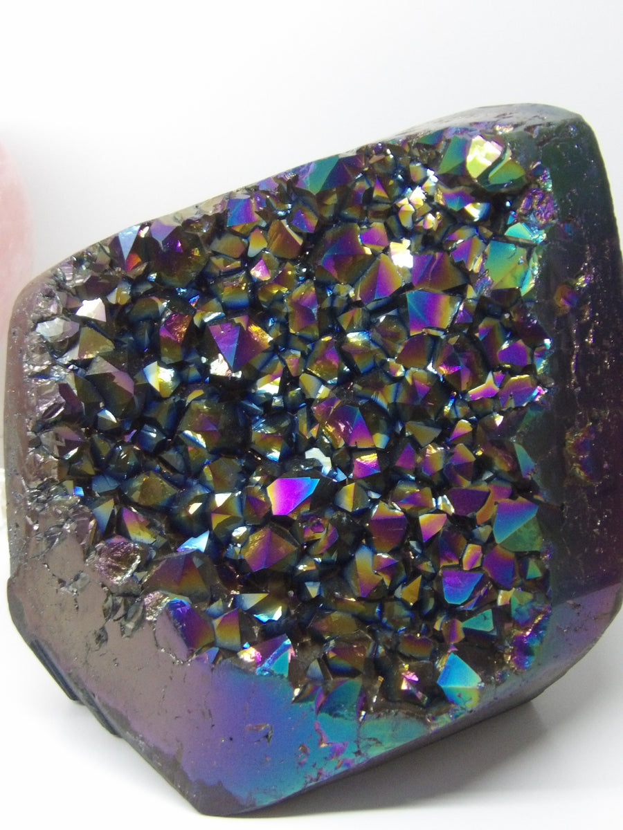 Multicolored Aura quartz crystal cluster on a white background