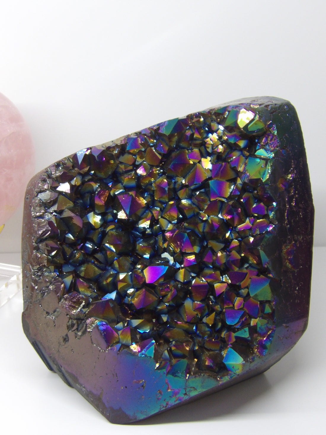 Multicolored Aura quartz crystal on a white background