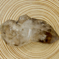 Natural double-terminated Brandberg Quartz from the Brandberg Massif, Erongo Region, Namibia with smoky coloration, internal inclusions, and a companion crystal.