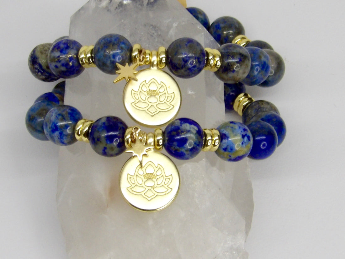 Handmade limited-edition Divine Insight Lapis Lazuli manifestation bracelets with 10mm blue gemstone beads, gold-plated spacers, lotus medallions, and star charms.