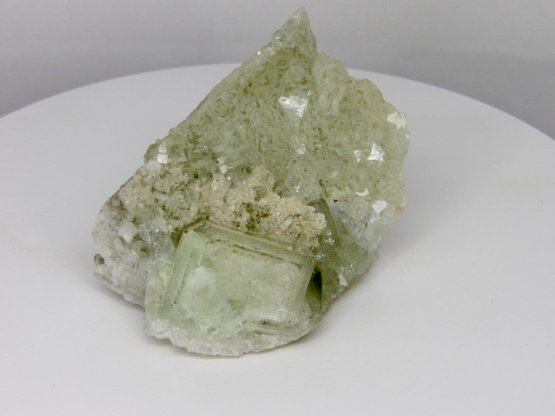 Glassy transparent UV-reactive fluorite crystal from Inner Mongolia, China with clear cubic crystals on a sparkling natural matrix.