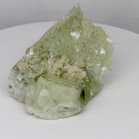 Glassy transparent UV-reactive fluorite crystal from Inner Mongolia, China with clear cubic crystals on a sparkling natural matrix.