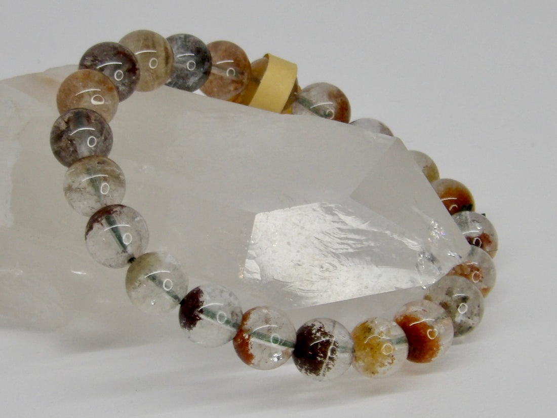 High-quality 10mm Garden Quartz bracelet featuring clear natural quartz beads with colorful red, green, brown, and earthy mineral inclusions.