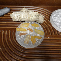 Small natural tangerine quartz points arranged on a selenite plate