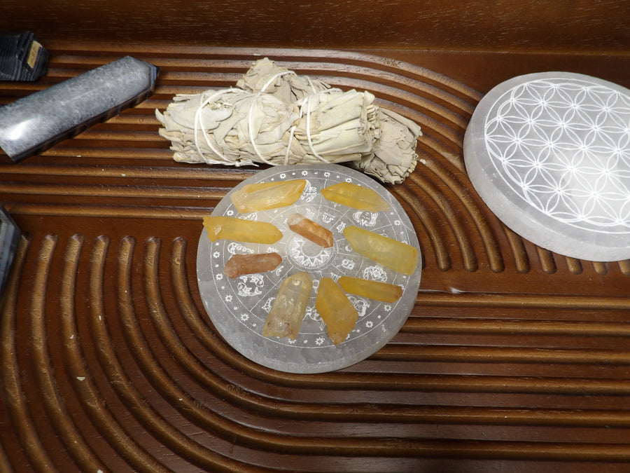 Small natural tangerine quartz points arranged on a selenite plate