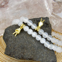 Handmade Protect Your Peace Bracelet featuring natural approximately 7 mm Selenite beads and an 18-karat gold-plated peace charm by Star Woman Crystals.