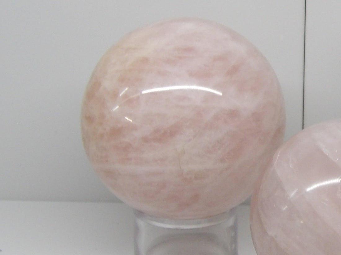 Polished rose quartz sphere on stand, heart chakra crystal