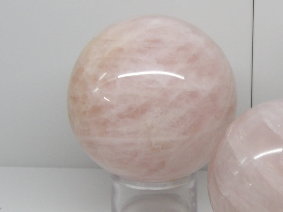 Polished rose quartz sphere on stand, heart chakra crystal