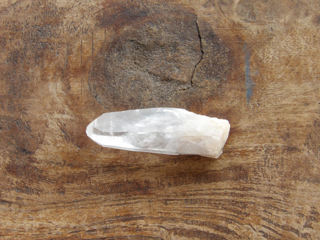 Natural clear quartz point with milky bottom
