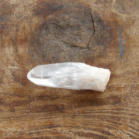 Natural clear quartz point with milky bottom