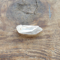 Twin Natural clear quartz point on wood table