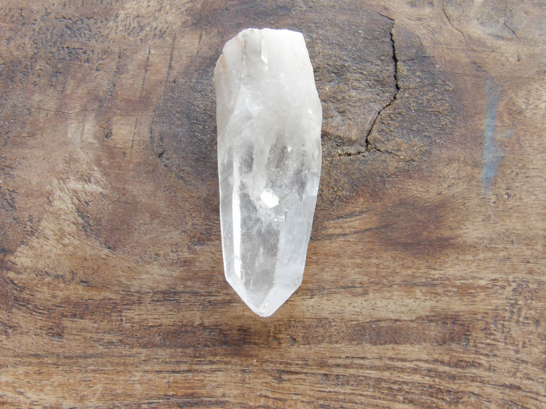 clear quartz point on brown table