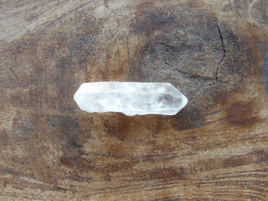Natural Clear crystal on a wooden surface