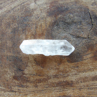 Natural Clear crystal on a wooden surface