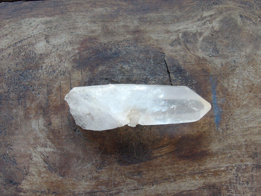 Clear quartz point on wooden table