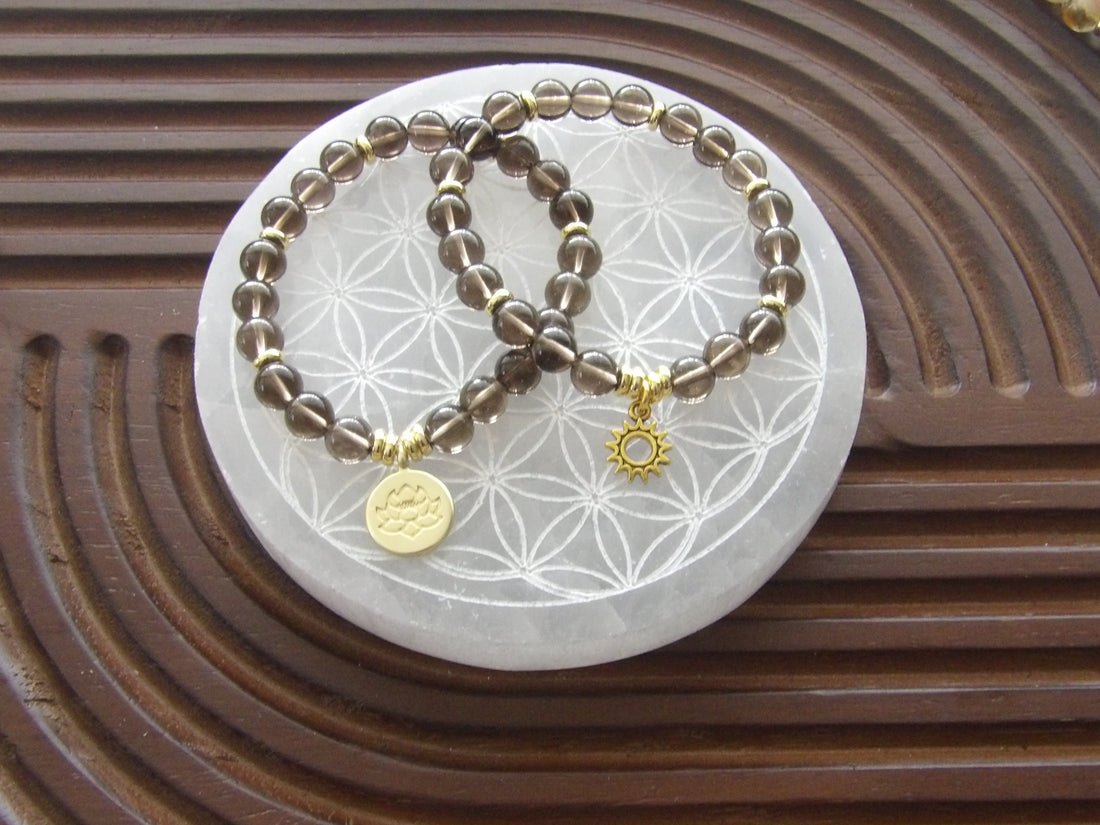 Smoky quartz grounding bracelet with 18k gold-plated lotus charm and gold spacers, limited edition.