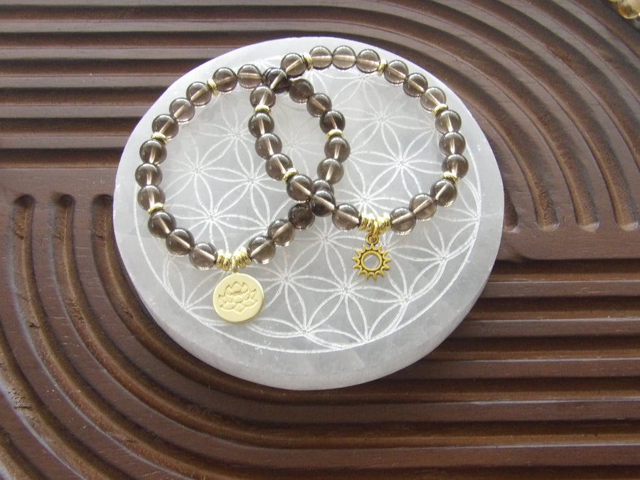 Smoky quartz grounding bracelet with 18k gold-plated lotus charm and gold spacers, limited edition.