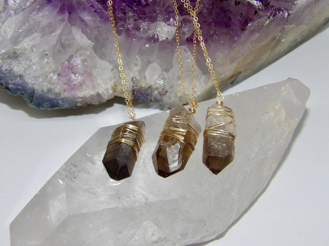 gold-wrapped smoky quartz crystal pendants on gold chains 