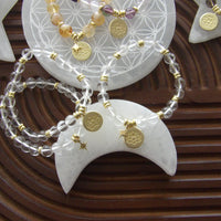 Clear quartz beaded bracelet with 18k gold-plated lotus charm, handmade exclusively for Star Woman Crystals.