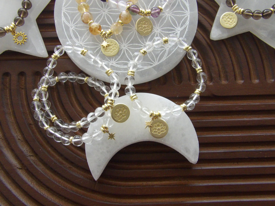 Clear quartz beaded bracelet with 18k gold-plated lotus charm, handmade exclusively for Star Woman Crystals.