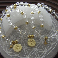 Divine Manifestation clear quartz bracelet with gold-plated lotus spacer beads.