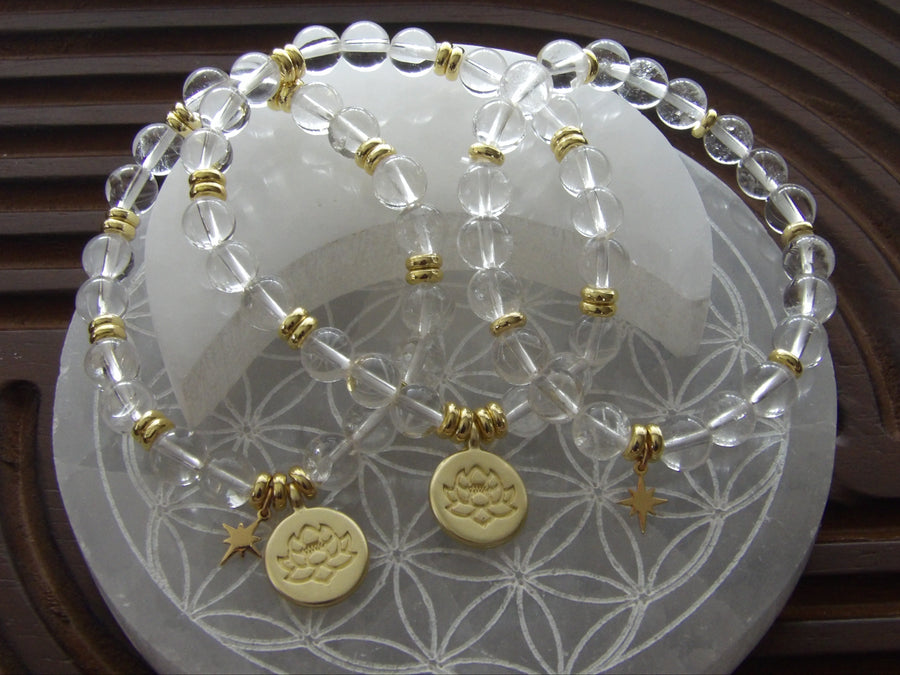 Divine Manifestation clear quartz bracelet with gold-plated lotus spacer beads.