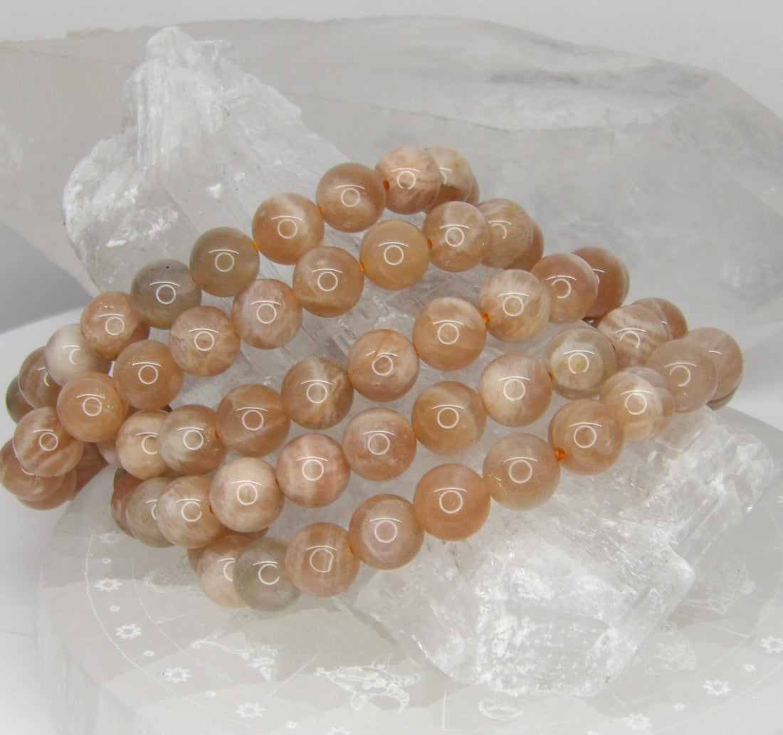 Natural 8mm Sunstone stretch bracelet with polished peach, champagne, cream, and gray gemstone beads.