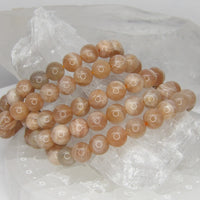 Natural 8mm Sunstone stretch bracelet with polished peach, champagne, cream, and gray gemstone beads.