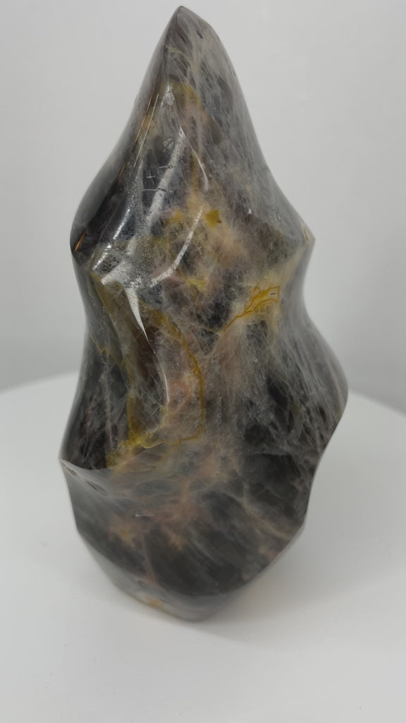 Black Moonstone Flame with silver flash and golden mineral veining