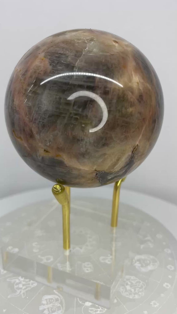Natural Black Moonstone sphere with soft silver sheen and distinctive feldspar patterning. Polished 300-gram sphere from Star Woman Crystals.
